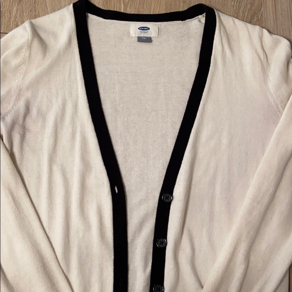 Cream colored cardigan with black accents
